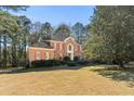 Beautiful brick home with a manicured lawn, red shutters, and a charming front entrance at 440 Dix Lee On Dr., Fayetteville, GA 30215