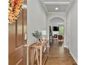 Inviting foyer with hardwood floors, a console table, and an arched entryway to the living area at 1570 Lenox Overlook Ne Rd, Atlanta, GA 30329