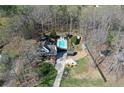 Aerial view of the property showcasing pool, home, outbuildings, and landscaping at 158 Lambeth Dr, Hiram, GA 30141