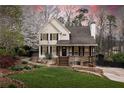 Charming two-story home with landscaped front yard, covered porch and blooming tree at 158 Lambeth Dr, Hiram, GA 30141