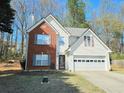 Charming two-story home with a brick and white siding facade and attached two-car garage at 1822 Hayden Mill Ct, Lawrenceville, GA 30043
