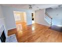 Open living area with hardwood floors leading to dining room and staircase at 1822 Hayden Mill Ct, Lawrenceville, GA 30043