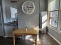 Bright dining area featuring a wooden table set, granite countertops, and stylish white cabinetry at 20 Marietta Nw St # 10E, Atlanta, GA 30303