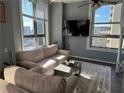 Inviting living room with large windows, city views, comfortable seating, and a decorative rug at 20 Marietta Nw St # 10E, Atlanta, GA 30303