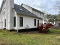 Back of the home showing a wood deck, lawn, and traditional white siding at 2105 Fair Ridge Ct, Jonesboro, GA 30236