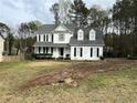 Traditional white home with black shutters, covered porch, and a spacious front yard at 2105 Fair Ridge Ct, Jonesboro, GA 30236