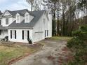 White home featuring an attached garage and a concrete driveway at 2105 Fair Ridge Ct, Jonesboro, GA 30236