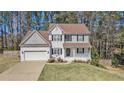 Traditional home with gray and white exterior, large front lawn, and a two-car garage at 2404 Caneridge, Marietta, GA 30064
