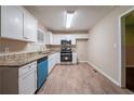 Modern kitchen with white cabinets, stainless steel appliances, and granite countertops at 3645 Larkspur Ter, Decatur, GA 30032