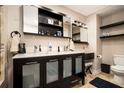 Bathroom with a double sink vanity with dark wood cabinets and a tile floor at 3501 Roswell Ne Rd, Atlanta, GA 30305
