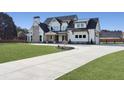 Beautiful two-story modern farmhouse with a long driveway, well-kept landscaping, and a side-entry garage at 195 Hope Hollow Rd, Loganville, GA 30052