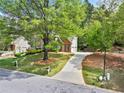 Suburban home with a long driveway and mature shade tree on a large lot at 535 Woodbrook Way, Lawrenceville, GA 30043