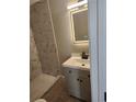 Stylish bathroom featuring a new vanity and lighted mirror adjacent to a walk-in shower at 4080 Brushymill Ct, Loganville, GA 30052