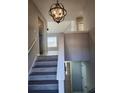 A well-lit staircase with modern wood-look flooring ascends to the upper level of the home at 4080 Brushymill Ct, Loganville, GA 30052