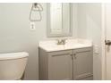 Neutrally painted bathroom, featuring a new vanity, cabinet and mirror at 679 Winchester Ln, Norcross, GA 30071