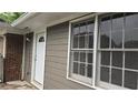 Rear view showing a modern siding and brick exterior with white trim, and windows overlooking the backyard at 679 Winchester Ln, Norcross, GA 30071