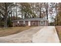 Well-maintained brick home featuring a cozy front porch and a wide driveway at 679 Winchester Ln, Norcross, GA 30071