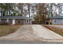 Inviting brick home with a concrete driveway, offering ample parking space and a welcoming entrance at 679 Winchester Ln, Norcross, GA 30071