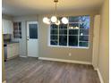 Bright dining room with wood floors, modern lighting, and a big window with natural light at 1148 Briarcliff Ne Rd # 1, Atlanta, GA 30306