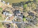 Captivating aerial view of luxurious lakefront homes with boat docks, set amidst lush, mature trees at 2220 Emerald Dr, Jonesboro, GA 30236