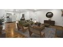Open-concept space features an airy living room with hardwood floors seamlessly connecting to other areas at 360 Peyton Sw Rd, Atlanta, GA 30311