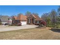 Beautiful brick home with an attached garage and mature landscaping at 160 Glenmore Ln, Mcdonough, GA 30253