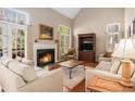Bright living room featuring a fireplace, large windows, and comfortable seating area at 3287 Rose Rdg, Atlanta, GA 30340