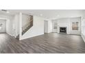 Spacious living room featuring hardwood floors, fireplace and ample natural light at 6910 Winchester Pl, Fairburn, GA 30213