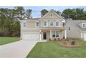 A spacious two-story home with a wide driveway, lush front yard, and a welcoming covered entryway at 254 Arnewood Cir, Mcdonough, GA 30253
