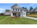 Beautiful two-story home featuring a lush green lawn, a cozy porch, and an attached garage at 138 Crabbswood Dr, Mcdonough, GA 30253