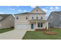 Beautiful two-story home with front porch, landscaped yard, and attached two-car garage at 537 Teversham Dr, Mcdonough, GA 30253