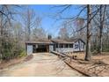 Charming ranch home features an open carport, a front porch and a spacious yard at 180 Sable Cir, Covington, GA 30016