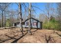 Side view of a cozy ranch home, featuring red shutters and an inviting front porch at 180 Sable Cir, Covington, GA 30016