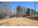 Expansive lot showing the home, multiple cars, and a detached shed in the background at 180 Sable Cir, Covington, GA 30016
