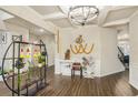 Open foyer with hardwood floors, elegant lighting, and architectural details at 224 Osier Dr, Mcdonough, GA 30252