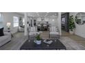 A view of the open-concept living room featuring modern decor, plenty of natural light, and seamless access to the kitchen at 2041 Briarcliff Ne Rd, Atlanta, GA 30329