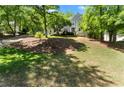 Charming two-story home featuring a lush green lawn and mature trees at 4223 N Mountain Ne Rd, Marietta, GA 30066