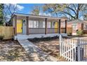 Well-maintained duplex showcasing its colorful entrance, landscaping, and inviting front yard at 1328 Sharon Street Nw, Atlanta, GA 30314