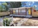 Charming front porch view of this lovely duplex featuring yellow doors and walkway at 1328 Sharon Street Nw, Atlanta, GA 30314
