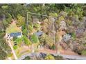 Expansive aerial view showcasing a charming home nestled on a spacious lot surrounded by lush greenery and mature trees at 195 Creekside Way, Mcdonough, GA 30252