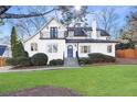 Beautiful two-story home with white exterior, featuring a cozy front porch and balcony, and a well-manicured lawn at 2993 Saint Annes Nw Ln, Atlanta, GA 30327