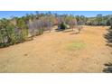 Vast, flat lot with open field with scattered trees, offering ample space and natural surroundings at 9095 Cedar Grove Rd, Fairburn, GA 30213