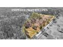 Aerial view showcasing the estimated property lines, displaying the expanse of land with surrounding trees and greenery at 9095 Cedar Grove Rd, Fairburn, GA 30213