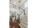 Spacious entry foyer with hardwood floors, staircase with carpet runner, and views into the adjacent living area at 1145 Verandah Se Ln, Atlanta, GA 30316