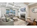 Cozy living room with coffered ceilings, fireplace with stone surround, and ample natural light from large windows at 1145 Verandah Se Ln, Atlanta, GA 30316