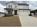 Charming two-story home with a two-car garage, inviting porch, and manicured lawn on an overcast day at 14 Ledgemont Way, Acworth, GA 30101