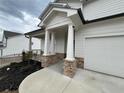View of the front porch showing the walkway, stone pillars, and entrance to the home at 14 Ledgemont Way, Acworth, GA 30101