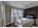Cozy bedroom featuring a decorative wood accent wall, wood flooring, and a ceiling fan at 24 Allatoona Landing Rd #29, Cartersville, GA 30121