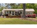 Inviting single story home featuring a quaint deck and beautiful landscaping for outdoor relaxation and enjoyment at 24 Allatoona Landing Rd #29, Cartersville, GA 30121