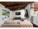 Bright living room featuring wood ceiling, fireplace, comfortable seating, and modern design at 3473 Regalwoods Dr, Atlanta, GA 30340